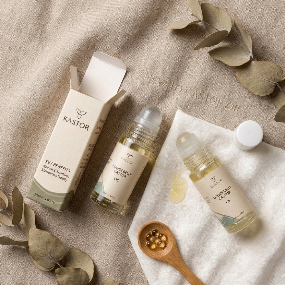 The Kastor lower belly castor oil rollers with their carton, laid out on linen
